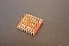 SOIC 14 pin array base for SMT Pads provides access for test socket attachment.