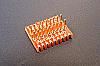 SOIC 18 pin array base for SMT Pads provides access for test socket attachment.