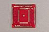 80 pad SMT, 0.8mm Pitch, TQFP breadboarding adapter with wireing holes 50 mils apart on the periphery. Can be used with individual wires, common ribbon cable, or header pins.