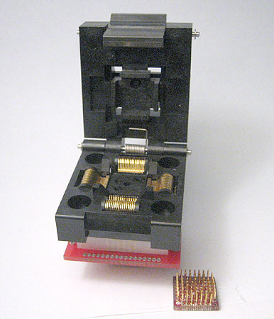 ZIF Clamshell closed top socket to SMT pads for 64 lead QFP package. 